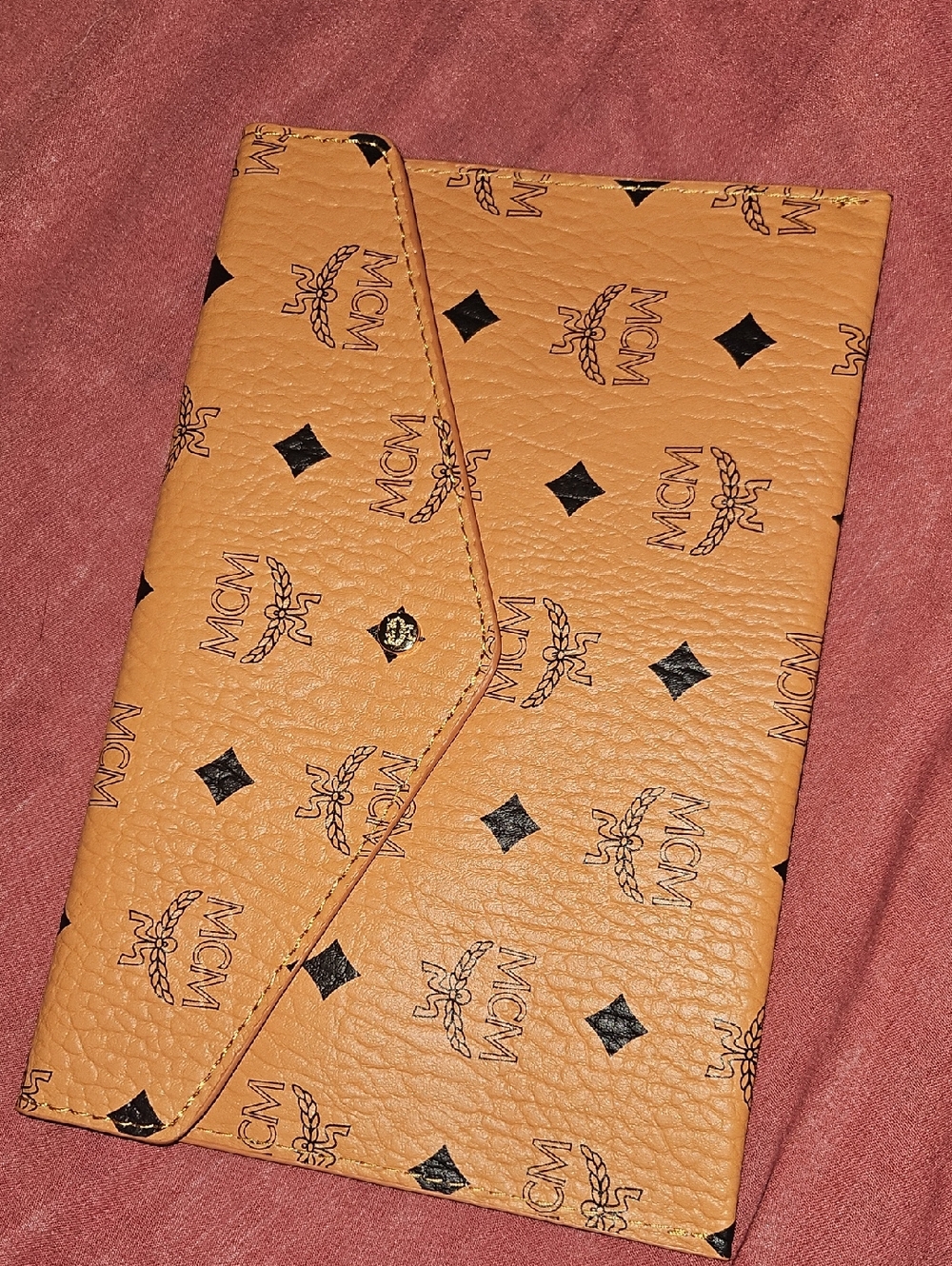 New MCM Visetos Envelope Clutch featuring an all-over monogram logo pattern.